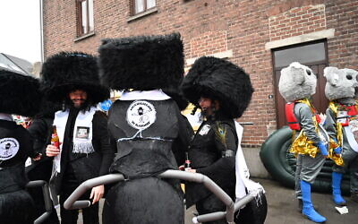 Participants of the Aalst Carnival wearing costumes combining ultra-Orthodox Jewish attire with ant limbs at the event in Aalst, Belgium on February 23, 2020. (Cnaan Liphshiz)