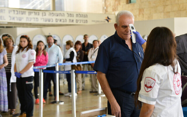 Illustrative: Medical personnel check travelers arriving at the Tel Aviv Ben Gurion Airport from Cairo for the Ebola viruson October 20, 2014. (Flash90) Illustrative: Medical personnel check travelers arriving at the Tel Aviv Ben Gurion Airport from Cairo for the Ebola viruson October 20, 2014. (Flash90)