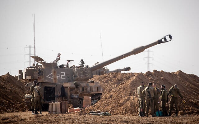 Israeli soldiers and artillery at a staging area in southern Israel, near the border with the Gaza Strip on November 13, 2019. (Yonatan Sindel/Flash90) Israeli soldiers and artillery at a staging area in southern Israel, near the border with the Gaza Strip on November 13, 2019. (Yonatan Sindel/Flash90)