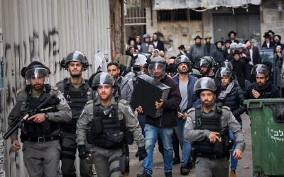Police officers seen during a raid on offices in the Mea Shearim neighborhood in Jerusalem on December 2, 2019. (Yonatan Sindel/Flash90)