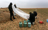 Illustrative: Palestinian men prepare a flammable object to be flown toward Israel, near the Israel-Gaza border east of Rafah in the southern Gaza Strip, on January 18, 2020. (Abed Rahim Khatib/ Flash90)