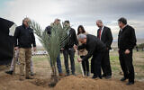 Prime Minister Benjamin Netanyahu plants a tree during an event for the Jewish holiday of Tu Bishvat, in the West Bank settlement of Mevo'ot Yeriho, in the Jordan Valley, February 10, 2020. (Flash90)