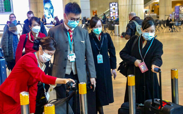 People wear face masks at Ben Gurion Airport following reports about the deadly coronavirus, February 17, 2020. (Avshalom Shoshani/Flash90) People wear face masks at Ben Gurion Airport following reports about the deadly coronavirus, February 17, 2020. (Avshalom Shoshani/Flash90)