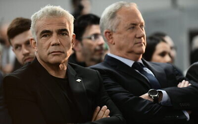 Yair Lapid (left) and Benny Gantz speak to supporters in Tel Aviv, on February 20, 2020. (Tomer Neuberg/Flash90)