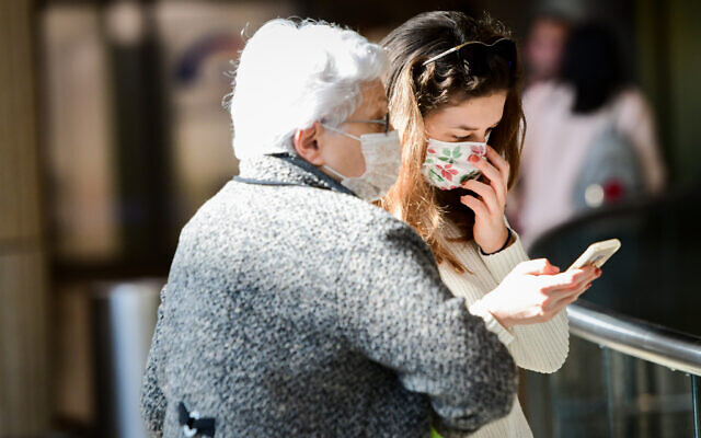 People wearing face masks against the coronavirus at Ben Gurion Airport on February 27, 2020. (Avshalom Shoshani/Flash90) People wearing face masks against the coronavirus at Ben Gurion Airport on February 27, 2020. (Avshalom Shoshani/Flash90)