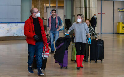 People wearing face masks at Ben Gurion International Airport on February 27, 2020. (Photo by Flash90)