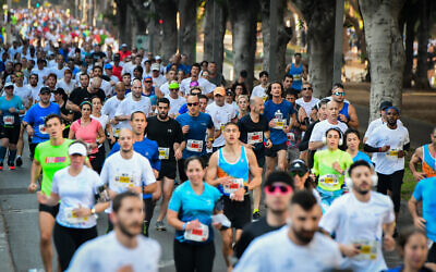 Runners take part in a marathon in Israel's coastal city of Tel Aviv on February 28, 2020 (Avshalom Sassoni‎‏/Flash90)