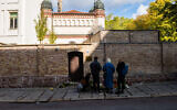 Visitors at the synagogue in Halle the day after a gunman targeted the house of worship in eastern Germany, October 10, 2019. (Jens Schlueter/Getty Images/via JTA)
