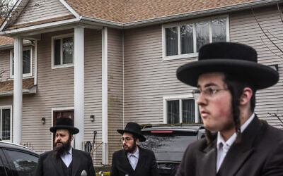 People gather in front of the Monsey house of Rabbi Chaim Rottenberg, the site of an attack at a Hanukkah party by a machete-wielding man, Dec. 29, 2019. (Stephanie Keith/Getty Images via JTA)