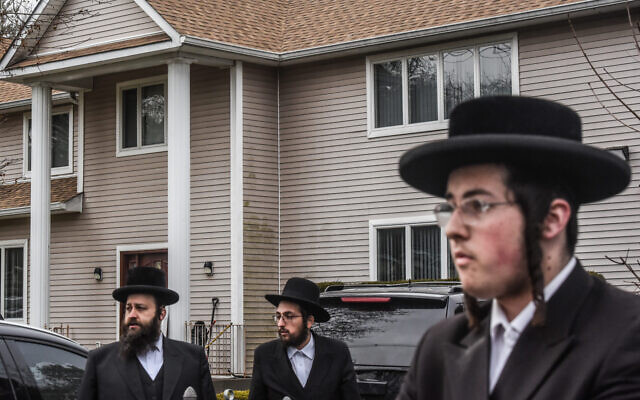 People gather in front of the Monsey house of Rabbi Chaim Rottenberg, the site of an attack at a Hanukkah party by a machete-wielding man, Dec. 29, 2019. (Stephanie Keith/Getty Images via JTA) People gather in front of the Monsey house of Rabbi Chaim Rottenberg, the site of an attack at a Hanukkah party by a machete-wielding man, Dec. 29, 2019. (Stephanie Keith/Getty Images via JTA)