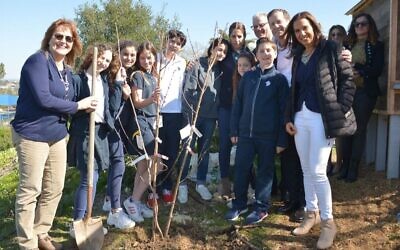 Isaac Herzog (2R) and Hagit Cohen-Hamo (R), mother of Ori Hamond, the lone soldier from San Diego injured in a ramming attack in Jerusalem on Feb. 6, plant a tree the following day with students at the San Diego Jewish Academy where Ori attended before making aliyah and where his mother teaches Hebrew. (Mark Garcia via JTA)
