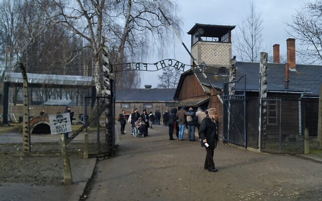 Visitors walk through the infamous gate reading 'Arbeit Macht Frei,' or 'work sets you free,' at the former site of Auschwitz-Birkenau, January 28, 2020. (Yaakov Schwartz/Times of Israel) Visitors walk through the infamous gate reading 'Arbeit Macht Frei,' or 'work sets you free,' at the former site of Auschwitz-Birkenau, January 28, 2020. (Yaakov Schwartz/Times of Israel)