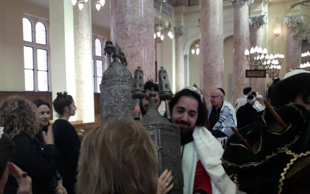 Keisar Zamir, center, grandson of an expat Egyptian Jew Levana Zamir, holds a Torah scroll in the renovated Alexandrian Eliyahu Hanavi Synagogue, February 15, 2020. (Courtesy)