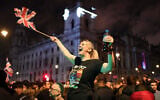 A Brexit supporter celebrates during a rally in Parliament square in London, England, Jan. 31, 2020. (AP Photo/Alberto Pezzali)