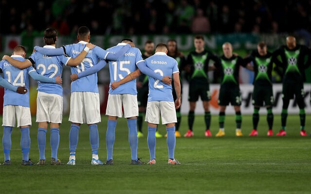 Players from Wolfsburg, rear, and Malmo, front, hold a minute of silence for the victims of the deadly attack in the German city of Hanau prior to a soccer match between VfL Wolfsburg and Malmo FF in Wolfsburg, Germany, Feb. 20, 2020. (AP Photo/Michael Sohn) Players from Wolfsburg, rear, and Malmo, front, hold a minute of silence for the victims of the deadly attack in the German city of Hanau prior to a soccer match between VfL Wolfsburg and Malmo FF in Wolfsburg, Germany, Feb. 20, 2020. (AP Photo/Michael Sohn)