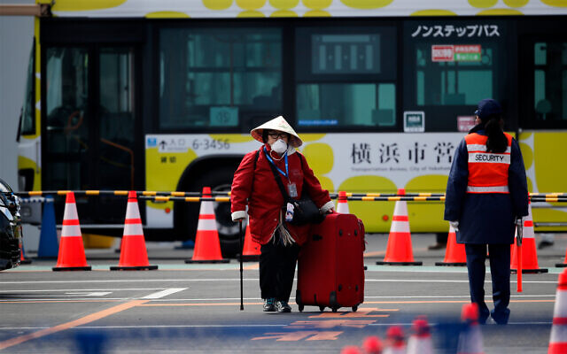 An unidentified passenger walks down after she disembarked from the quarantined Diamond Princess cruise ship, Feb. 19, 2020, in Yokohama, near Tokyo. (AP Photo/Jae C. Hong) An unidentified passenger walks down after she disembarked from the quarantined Diamond Princess cruise ship, Feb. 19, 2020, in Yokohama, near Tokyo. (AP Photo/Jae C. Hong)