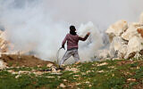 Palestinian demonstrators clash with Israeli forces during a protest in the village of Kfar Qaddum, near the West Bank city of Nablus February 14, 2020. (Nasser Ishtayeh/Flash90)