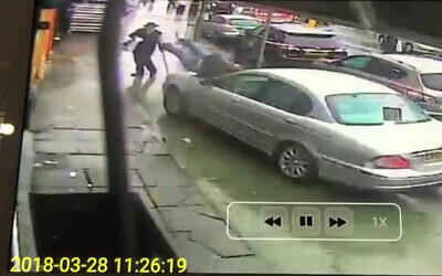 A rabbi accidentally plows a Jaguar into two pedestrians on a London sidewalk, March 2018. (Screenshot)