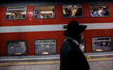 Illustrative: Passengers at Yitzhak Navon train station in Jerusalem, December 18, 2019. (Yonatan Sindel/Flash90)