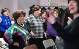 Holocaust survivors Edith Jacobs, Shirley Fernbach, Jean Kurtz, Adele Rubinstein, and Eva Friedman attend an exercise class led by Mindy Landau at Nachas Health and Family Network in Brooklyn, New York, January  22, 2020. (AP Photo/Emily Leshner)