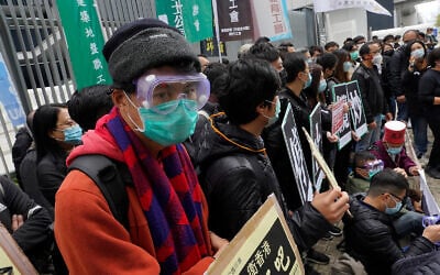 Medical staff strike over coronavirus concerns outside government headquarters in Hong Kong, February 5, 2020. (AP Photo/Vincent Yu)