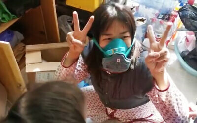 Ofer Dekel's wife, Nana, celebrates finding a protective mask at their apartment in Wuhan, China, in a video posted to Facebook on February 5, 2020. (Facebook screenshot)
