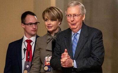 Senate Majority Leader Mitch McConnell, right, walks to meet with Senate Republicans on Capitol Hill in Washington after the Senate voted to not allow witnesses in the impeachment trial of US President Donald Trump, January 31, 2020. (AP Photo/Jacquelyn Martin)