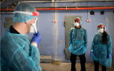 Hospital staff prepare for the arrival of a Chinese woman at the Shaare Zedek Medical Center in Jerusalem amid fears she is infected with the coronavirus, January 27, 2020. (Yonatan Sindel/Flash90)