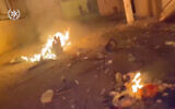 Debris burns at the scene of a brawl in Rahat in footage published by police, February 7, 2020. (Israel police)