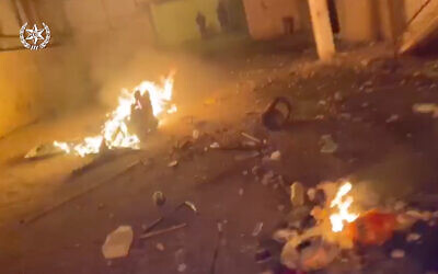 Debris burns at the scene of a brawl in Rahat in footage published by police, February 7, 2020. (Israel police)