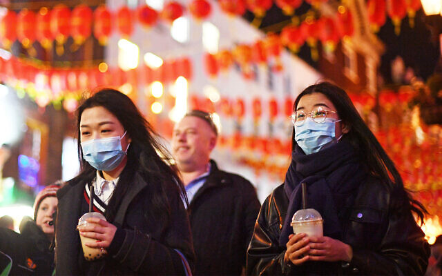People wearing masks walk in China Town, in London,, Feb. 1, 2020. (Victoria Jones/PA via AP) People wearing masks walk in China Town, in London,, Feb. 1, 2020. (Victoria Jones/PA via AP)