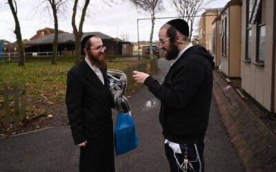Jacob Gross, right, speaks to a Canvey Island resident outside the town’s synagogue, December 13, 2019. (Cnaan Liphshiz/JTA)