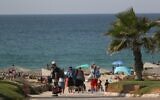 Israelis enjoy the Palmachim beach in southern Israel, October 21, 2016. (Nati Shohat/Flash90)