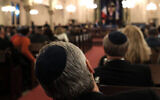 An illustrative photo of people listening to a speaker at a synagogue. (Spencer Platt/Getty Images via JTA)