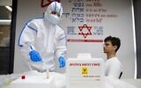 A Magen David Adom paramedic performs a coronavirus test on a volunteer at the coronavirus national operations center in Kiryat Ono, February 26, 2020. (Jack Guez/AFP)
