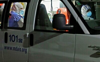 Illustrative: An ambulance carrying a patient displaying symptoms of the coronavirus, as the vehicle arrives at Sheba Medical Center in Tel Hashomer on February 28, 2020. (Jack Guez/AFP)