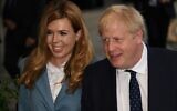 In this photo taken on September 28, 2019, Britain's Prime Minister Boris Johnson (R) walks with his partner Carrie Symonds at The Midland, near the Manchester Central convention complex in Manchester, northwest England, on the eve of the annual Conservative Party conference. (Photo by Oli SCARFF / AFP)