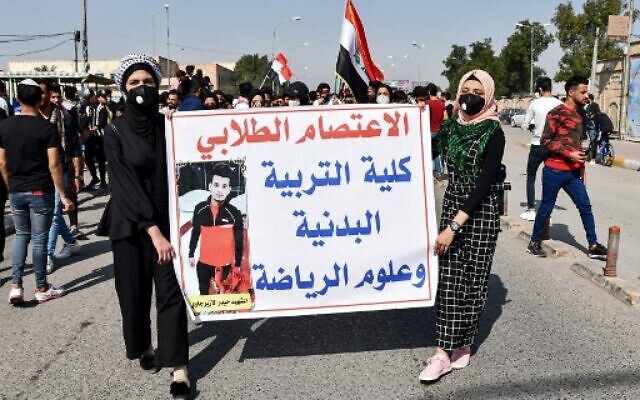 Student protesters wearing protective face masks march with a sign during an anti-government demonstration in Iraq's southern city of Nasiriyah in Dhi Qar province on March 1, 2020. (AFP Photo Asaad Niazi) Student protesters wearing protective face masks march with a sign during an anti-government demonstration in Iraq's southern city of Nasiriyah in Dhi Qar province on March 1, 2020. (AFP Photo Asaad Niazi)