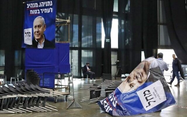 A laborer sorts election posters bearing the portrait of Prime Minister Benjamin Netanyahu, at the Likud party's electoral campaign headquarters in Tel Aviv, on March 2, 2020. (Jack GUEZ / AFP) A laborer sorts election posters bearing the portrait of Prime Minister Benjamin Netanyahu, at the Likud party's electoral campaign headquarters in Tel Aviv, on March 2, 2020. (Jack GUEZ / AFP)