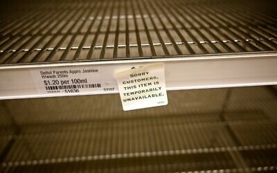 Shelves are empty of hand sanitizer in a supermarket in Sydney on March 4, 2020. (Photo by PETER PARKS / AFP)