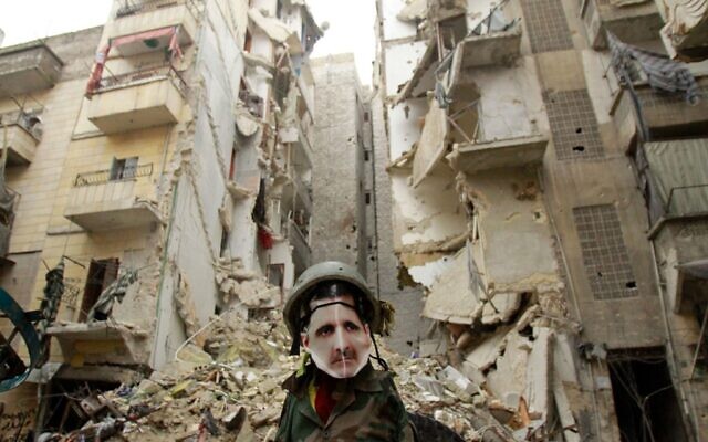 In this file photo taken on January 5, 2013, a dummy dressed up in army fatigue and a mask depicting Syrian President Bashar Assad is erected in the Salaheddine neighborhood of Aleppo, the scene of heavy fighting. (Photo by MAURICIO MORALES / AFP) In this file photo taken on January 5, 2013, a dummy dressed up in army fatigue and a mask depicting Syrian President Bashar Assad is erected in the Salaheddine neighborhood of Aleppo, the scene of heavy fighting. (Photo by MAURICIO MORALES / AFP)