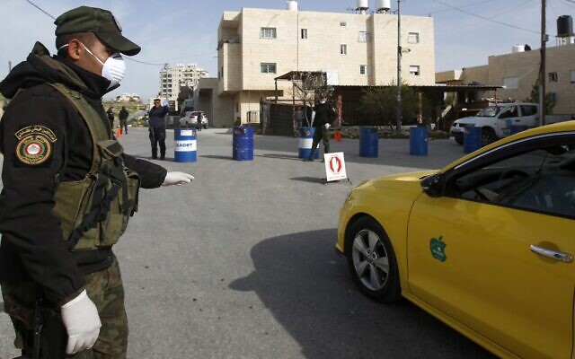 Palestinian Authority security forces man a checkpoint at one of the entrances to the West Bank city of Bethlehem on March 10, 2020, currently under lockdown due to coronavirus. (Musa Al Shaer/AFP) Palestinian Authority security forces man a checkpoint at one of the entrances to the West Bank city of Bethlehem on March 10, 2020, currently under lockdown due to coronavirus. (Musa Al Shaer/AFP)