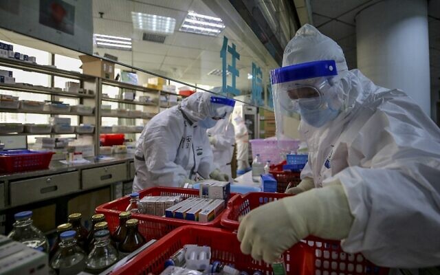 Illustrative: Medical staff arrange medicine at Red Cross Hospital in Wuhan in China's central Hubei province on March 10, 2020. (STR/AFP) Illustrative: Medical staff arrange medicine at Red Cross Hospital in Wuhan in China's central Hubei province on March 10, 2020. (STR/AFP)