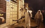 Iranian firefighters disinfect streets and alleys in southern Tehran to halt the spread of coronavirus on March 11, 2020 (ATTA KENARE / AFP)