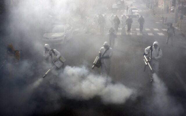Iranian firefighters disinfect streets in the capital Tehran in a bid to halt the wild spread of coronavirus on March 13 2020. (AFP) Iranian firefighters disinfect streets in the capital Tehran in a bid to halt the wild spread of coronavirus on March 13 2020. (AFP)