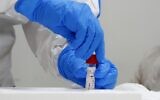 A Magen David Adom paramedic seals a coronavirus screening test kit during a training exercise in the central city of Kiryat Ono on February 26, 2020. (Jack Guez/AFP)
