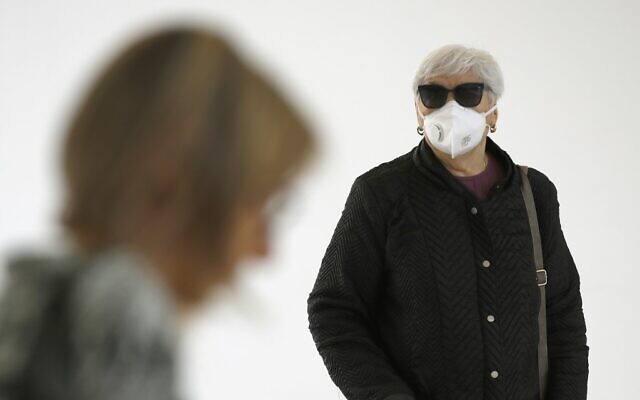 People wearing protective masks arrive at Samson Assuta Ashdod University Hospital on March 16, 2020, in the southern Israeli city of Ashdod. (JACK GUEZ / AFP) People wearing protective masks arrive at Samson Assuta Ashdod University Hospital on March 16, 2020, in the southern Israeli city of Ashdod. (JACK GUEZ / AFP)