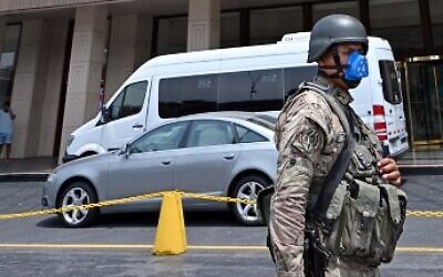 A Peruvian army soldier patrols close to a hotel in Lima on March 16, 2020, one day after President Martin Vizcarra announced a State of Emergency and a two-week nationwide home-stay quarantine together with the closure of all borders to fight the spread of the novel coronavirus.  (Photo by Cris Bouroncle / AFP)