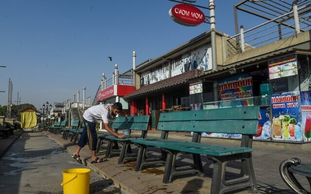 A worker cleans benches in front of closed food street stalls after a ban for public imposed by the national authorities amid concerns over the spread of the COVID-19 novel coronavirus, in Karachi on March 18, 2020. (Asif Hassan/AFP) A worker cleans benches in front of closed food street stalls after a ban for public imposed by the national authorities amid concerns over the spread of the COVID-19 novel coronavirus, in Karachi on March 18, 2020. (Asif Hassan/AFP)
