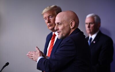 US President Donald Trump listens to FDA Commissioner Stephen Hahn (R) speak on the latest developments in the coronavirus outbreak, in the James Brady Press Briefing Room at the White House in Washington, March 19, 2020. (Brendan Smialowski/AFP)